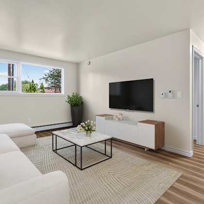 a living room with a white couch and a black coffee table.
