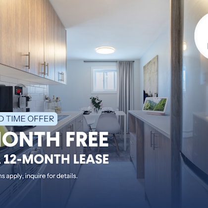 a kitchen interior with a sign offering a free month on a lease.