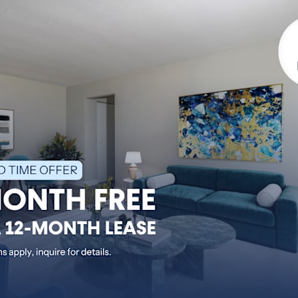 a living room with a couch, a table, and a painting on the wall.