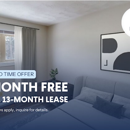 a room with a couch and a poster advertising a free month on a lease.