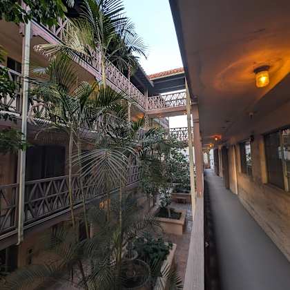 a long corridor with a balcony on the left and a long hallway on the right.