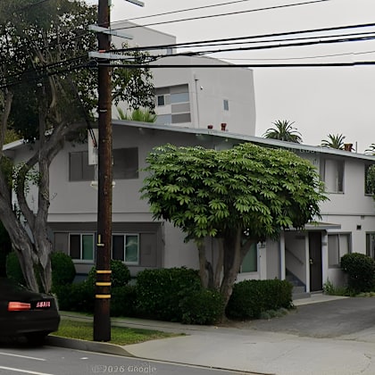 a black car is parked on the side of a street.