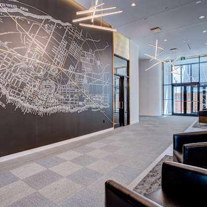 a large map of a city is displayed on a wall in a modern lobby.