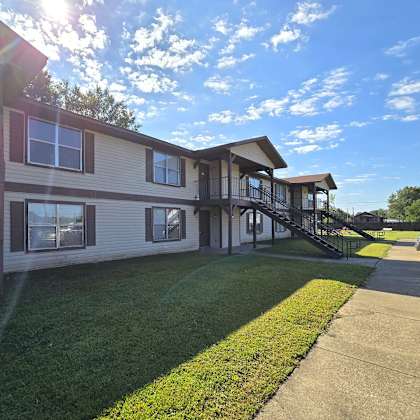 a sunny day at a residential complex with a clear blue sky.