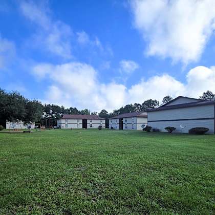 a grassy field with a building in the background.