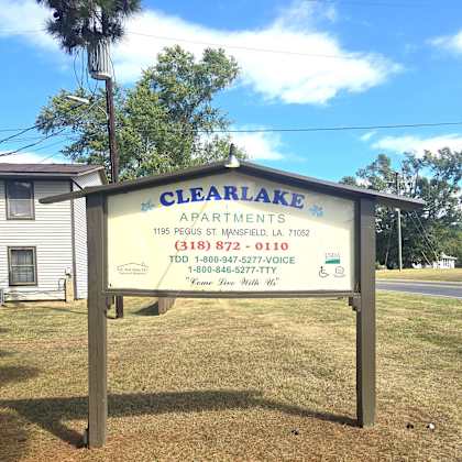 a sign for clearlake apartments is displayed in front of a house.