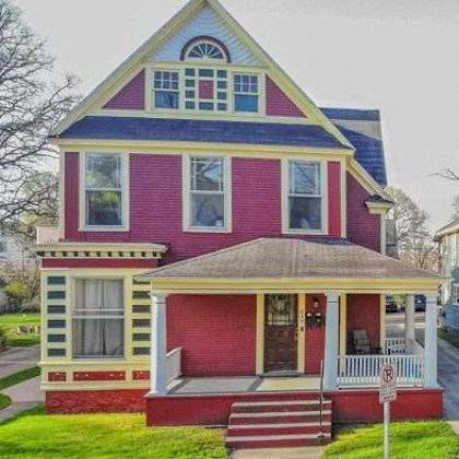 a two-story house with a red and blue exterior.