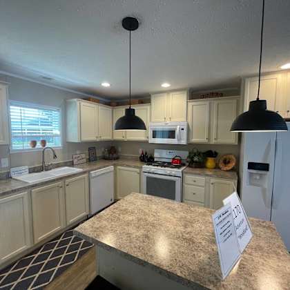 a kitchen with a granite counter top and a sign on it.