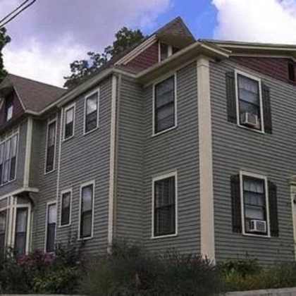 a grey house with a sign that says wealthy st.