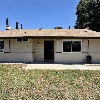 a house with a brown roof and a black door.