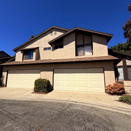 a house with a garage door and a driveway.