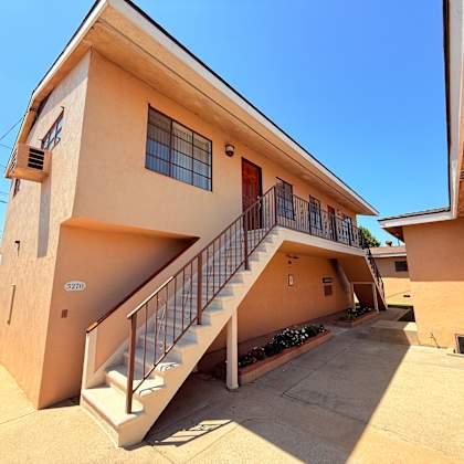 a two-story house with a staircase leading to the upper level.