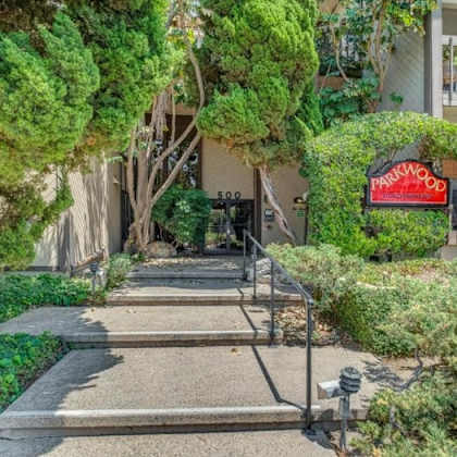 a pathway leads to a building with a red sign that says "pamuklu".