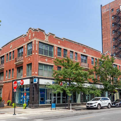 a red brick building with a blue sign on the front.