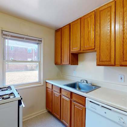 a kitchen with wooden cabinets and white appliances.