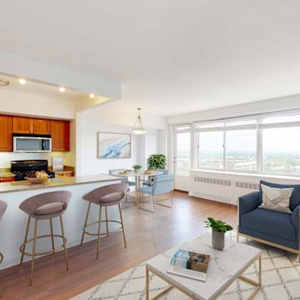 a living room with a bar area and a view of the city.