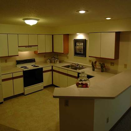 a kitchen with white cabinets and a counter.