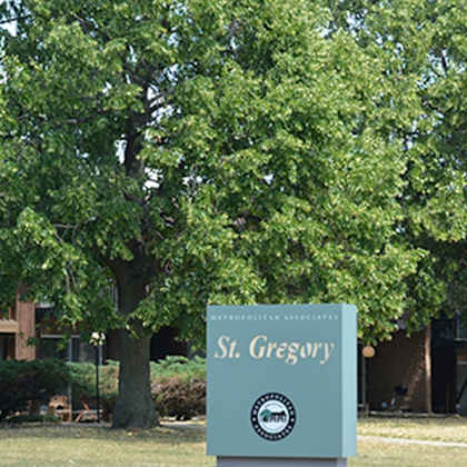 a sign for st. gregory stands in front of a building.