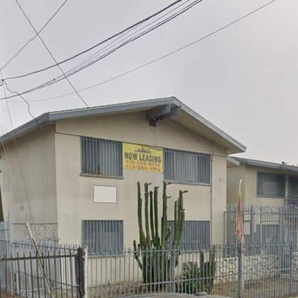 a building with a sign that says "now lease" in front of it.