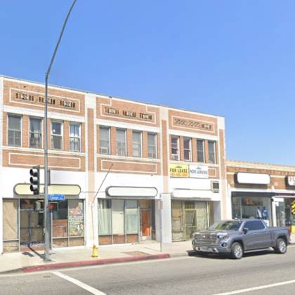 a street view of a building with the sign "teen film night" on the top floor.