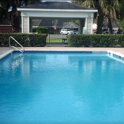 a small pool with a white fence around it.