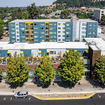 an aerial view of a building with trees in front of it