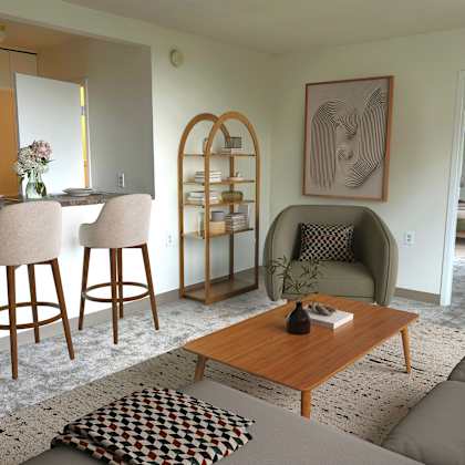 a living room with a brown wooden coffee table and a grey sofa.