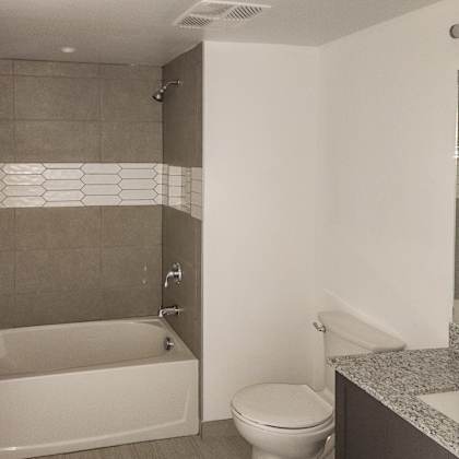 a bathroom with a toilet and a tub and a sink at meridian point at goulds station in miami, fl, 33170