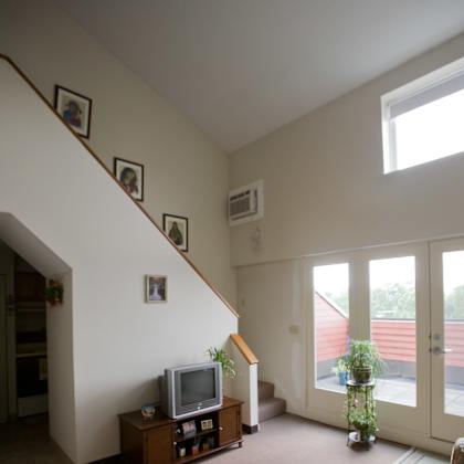 a living room with a tv and a staircase