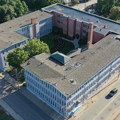 an aerial view of a building with a gray roof