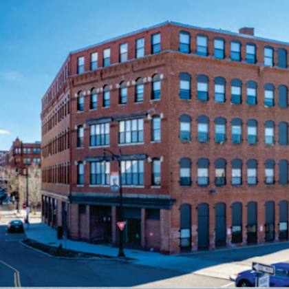 a red brick building on the corner of a city street
