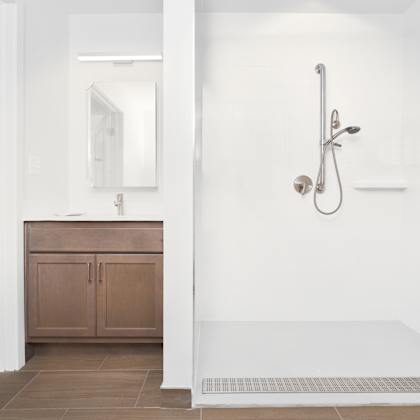 a white bathroom with a shower and a sink