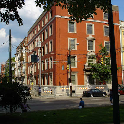 a large red brick building on a city street