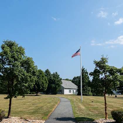 a flag is flying in front of a house.