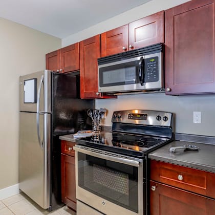 a kitchen with a refrigerator, oven, and microwave.