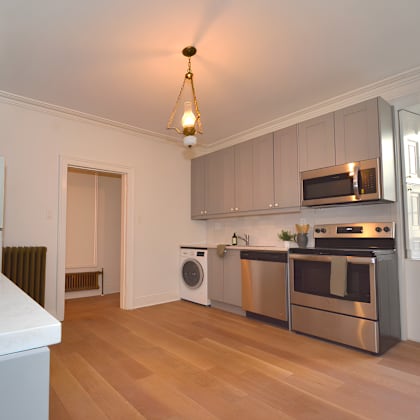 a kitchen with a white counter top and stainless steel appliances.