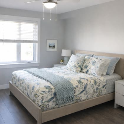 a bedroom with a large bed and a ceiling fan.