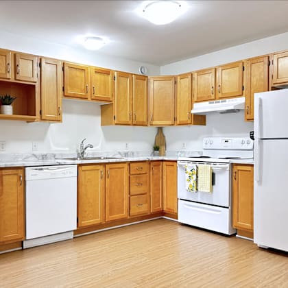 a kitchen with wooden cabinets and white appliances.