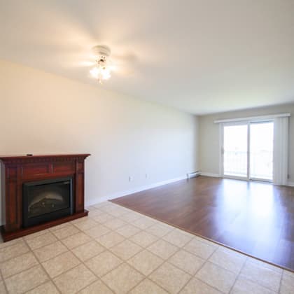 a room with a fireplace and tile flooring.