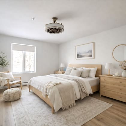 a bedroom with a large bed, a chair, and a plant.
