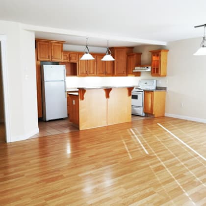 a kitchen with wooden cabinets and a white refrigerator.