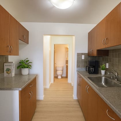 a kitchen with brown cabinets and a white refrigerator.