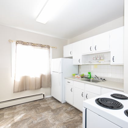 a kitchen with white appliances and cabinets.