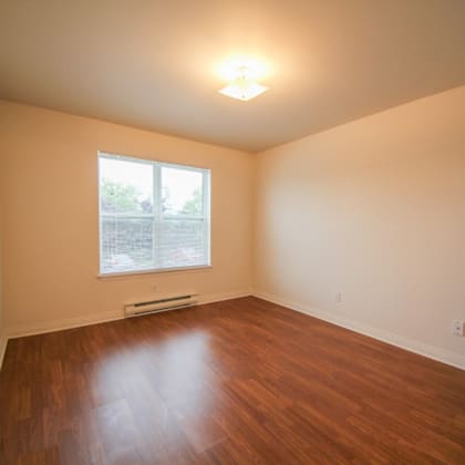 empty room with wooden floor and a window.