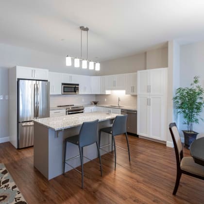 a kitchen with a white countertop and a refrigerator.
