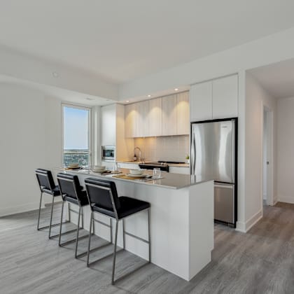 a modern kitchen with a large island and stainless steel appliances.