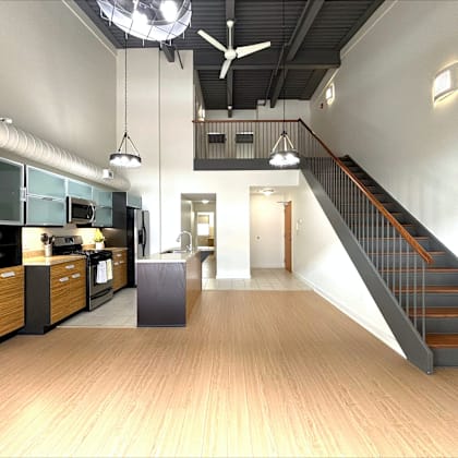 a modern kitchen with a staircase leading to the upper floor.