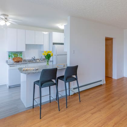 two chairs are placed in front of a kitchen island.