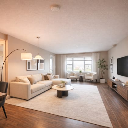 a modern living room with a large sectional sofa, a coffee table, and a flat-screen tv.