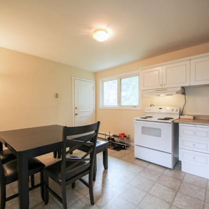 a kitchen with a table and chairs.